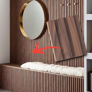 May include: A wall covered in vertical dark brown wood slats featuring a round gold-rimmed mirror, three small gold hooks, and a long bench with a white tufted cushion. A sample of the wood slat panel is shown floating with a red arrow pointing to it.