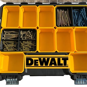 May include: A black and yellow DEWALT organizer with multiple compartments filled with screws. The organizer has a clear lid and metal latches. The DEWALT logo is prominently displayed on the front.