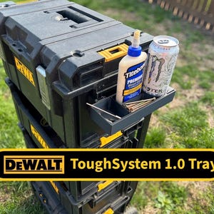 May include: Black and yellow DEWALT ToughSystem 1.0 Tray. The tray holds a bottle of wood glue, a can of energy drink, and screws. The tray is part of a stackable tool storage system.