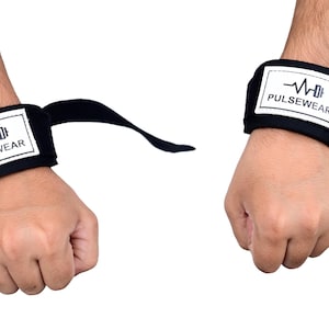 May include: Black wrist wraps with white rectangular patches featuring the text "PULSEWEAR" and a graphic of a heartbeat and a weight. The wraps are designed for weightlifting and fitness activities.