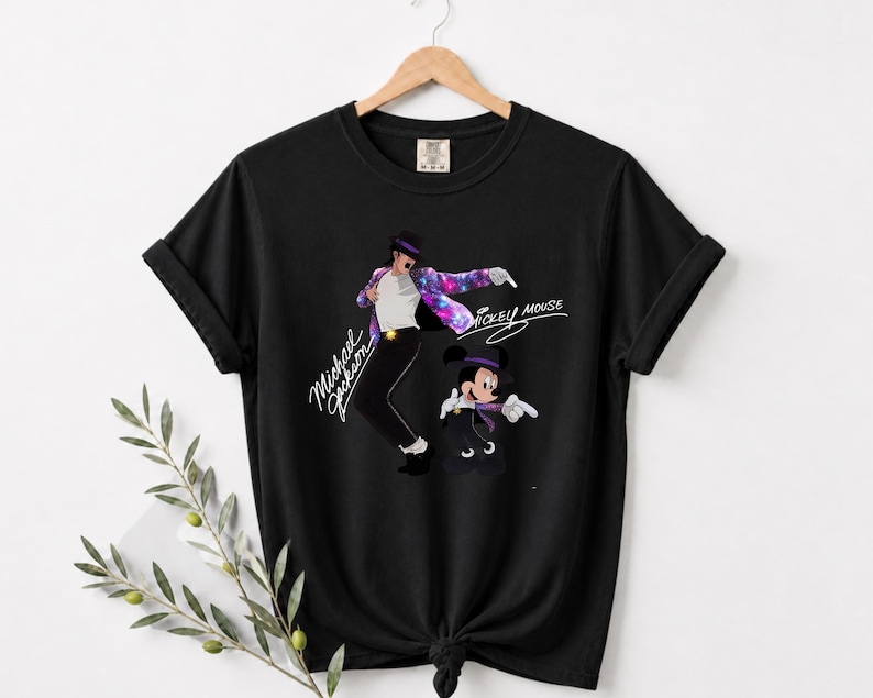 Unisex t-shirt, sweatshirt, hoodie, and baby bodysuit featuring a Michael Jackson and Mickey Mouse dancing graphic with galaxy jacket details and pop icon theme.