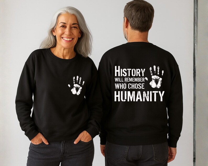 May include: Black sweatshirt with a white handprint on the front and the text "History Will Remember Who Chose Humanity" on the back. The sweatshirt is a crew neck style.