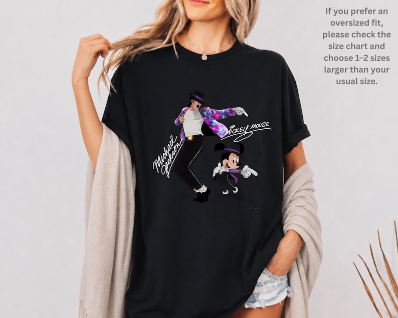 Unisex t-shirt, sweatshirt, hoodie, and baby bodysuit featuring a Michael Jackson and Mickey Mouse dancing graphic with galaxy jacket details and pop icon theme.