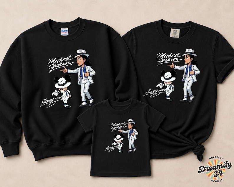 May include: Black sweatshirts and t-shirts featuring a cartoon illustration of Michael Jackson and Mickey Mouse. The design includes the text "Michael Jackson" and "Mickey Mouse" in a script font. The apparel is suitable for a family.