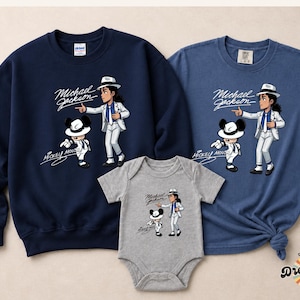May include: Navy blue sweatshirt, blue t-shirt, and gray baby onesie featuring a cartoon illustration of Michael Jackson and Mickey Mouse. The graphic includes the text "Michael Jackson" and "Mickey Mouse".