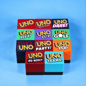 May include: A collection of eleven square blocks featuring various UNO game logos and titles including UNO Dare, Flex, Flip, Golf, Liar's, Party, Pop, No Mercy, and Teams. Each block displays the iconic yellow and red UNO branding on a colored background.