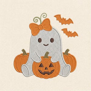 May include: An embroidery design featuring a white ghost with a large orange bow on its head, sitting between two plain orange pumpkins and holding a third orange jack-o'-lantern pumpkin. Two small orange bats are positioned to the right side.