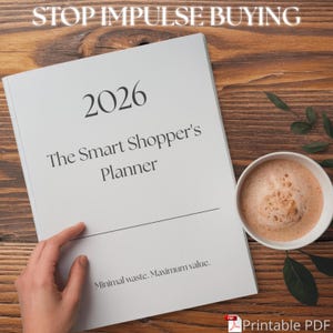 May include: A white planner titled "2026 The Smart Shopper's Planner" with the text "Stop Impulse Buying" above it. A cup of coffee sits to the right. The planner's text reads "Minimal waste. Maximum value."