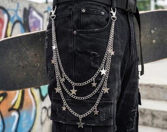 May include: Black denim cargo pants with a black belt and silver chain with star pendants. The chain is attached to the belt loops and pocket. The pants have a distressed look.