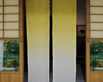 May include: Two rectangular, vertically-oriented, linen curtains hang in a doorway. The curtains transition from a yellow-green at the top to white at the bottom. The doorway is framed by wooden panels and a traditional Japanese-style sliding door.