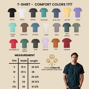 May include: A display of Comfort Colors 1717 t-shirts in various colors, including black, white, and blue jean. The image also shows a size chart with measurements in inches and the Golden Cotton US logo. A person is wearing a dark green t-shirt.