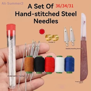 May include: A collection of hand-stitched steel needles and sewing accessories. The set includes needles, spools of thread in multiple colours, thimbles, a needle threader, and a thread removal knife. The thread spools are in brown, black, red, white, and blue.