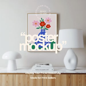 May include: A framed poster mockup featuring a floral illustration in a blue vase. The text "poster mockup" is overlaid on the image. Two white lamps and a stack of books are on a wooden surface. The text "Display Your Prints Beautifully" is also visible.