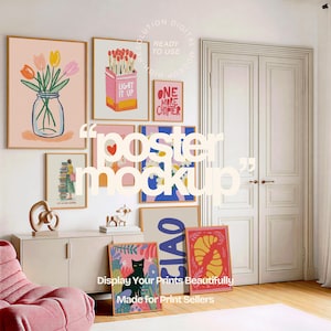 Op de afbeelding: Een verzameling ingelijste kunstprints in verschillende maten en stijlen, waaronder bloemen, abstracte en tekstgebaseerde ontwerpen. De prints worden weergegeven op een witte muur, met een roze fauteuil en een houten vloer op de voorgrond. De tekst "Display Your Prints Beautifully" is zichtbaar.