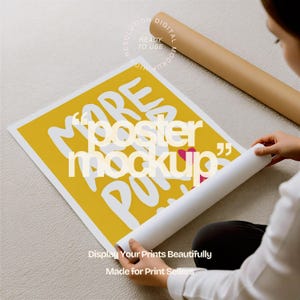 May include: A yellow poster mockup with white text that reads "MORE POSTER MOCKUP". A person is rolling out a white poster. A brown poster tube is in the background. The text "Display Your Prints Beautifully" and "Made for Print Sellers" is at the bottom.