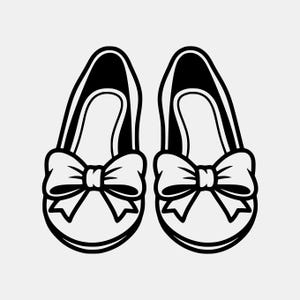 May include: A pair of black and white baby shoes with large bow accents. The shoes have a rounded toe and a strap that goes over the top of the foot. The bows are centered on the front of each shoe.