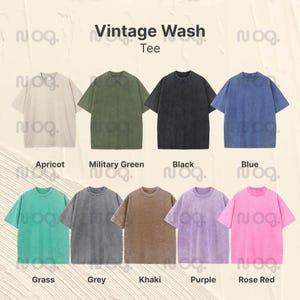 K&ouml;nnte beinhalten: Eine Auswahl von acht Vintage-Wash-T-Shirts in verschiedenen Farben: Aprikot, Milit&auml;rgr&uuml;n, Schwarz, Blau, Gras, Grau, Khaki, Lila und Rosenrot. Der Text "Vintage Wash Tee" ist oben abgebildet.
