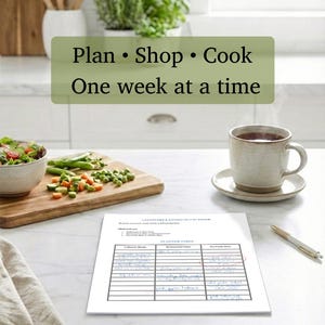 May include: A kitchen scene with a meal planning theme. A wooden cutting board holds vegetables, a bowl of salad, and a mug of tea sits on a marble countertop. A printed planner with handwritten notes and the text "Plan &bull; Shop &bull; Cook One week at a time" is visible.