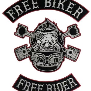 May include: Black and white embroidered biker patch with the words "FREE BIKER" and "FREE RIDER". The central design features a skull wearing goggles and crossed pistons.