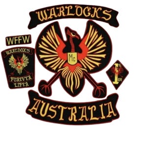 May include: A collection of Warlocks Australia patches. The central patch features a red phoenix with yellow wing details, the text "Mc" and a red heart. Other patches include the text "WFFW", "Forever Lifer", and "1% ER".