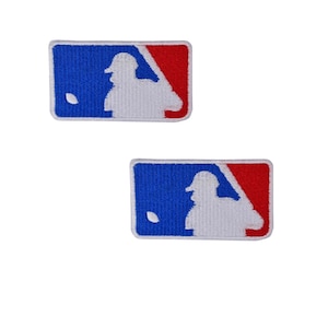 May include: Two embroidered patches featuring the MLB logo. Each patch has a blue background with a white batter silhouette and a red corner. The patches are rectangular and have a white border.