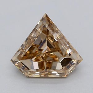 May include: A loose, shield-cut gemstone with a light brown, champagne-colored hue. The stone features a faceted surface with a triangular top point and a flat base, displaying intricate geometric light reflections throughout its transparent body.