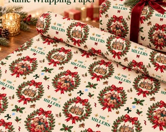 May include: Cream-colored wrapping paper featuring a repeating pattern of green holly wreaths, red bows, and small houses. Each wreath contains a photo of a family and a dog, with the text The Millers printed in green.