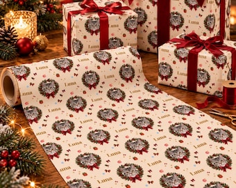 May include: A roll of cream-colored wrapping paper featuring a repeating pattern of a cat face inside a green wreath with a red bow and the name Luna printed in brown text. Several gift boxes wrapped in the same paper are tied with red ribbons.
