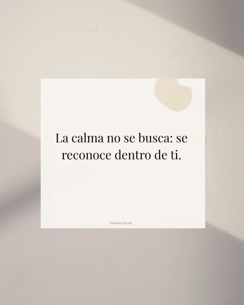 Op de afbeelding: Een vierkante, gebroken witte kaart met de tekst "La calma no se busca: se reconoce dentro de ti." in het zwart. De woorden zijn gecentreerd op de kaart. De kaart heeft een kleine, lichtbruine vorm in de rechterbovenhoek. De woorden "Serenity Studio" staan onderaan.
