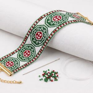 May include: A wide woven bracelet featuring a repeating geometric pattern in white, green, and red. The bracelet has gold-tone metal end caps and an adjustable chain clasp. Included are a silver sewing needle, clear thread, and loose beads.
