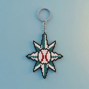 May include: A beaded keychain featuring a star-shaped design with a central baseball motif. The star is crafted from white, teal, and black beads, while the baseball center is white with red stitching. It includes a silver-toned metal ring.