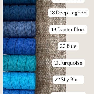 May include: A selection of blue and teal macrame cord spools. The colors range from dark teal to light blue, with labels indicating each shade: Dark Teal, Deep Lagoon, Denim Blue, Blue, Turquoise, Sky Blue, and Light Blue.