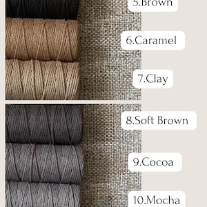 May include: Close-up of spools of twine in various shades of brown, including black, caramel, clay, soft brown, cocoa, and mocha. A textured fabric sample is next to the spools, with the color names labeled.