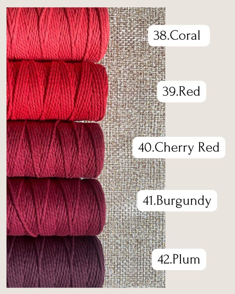 May include: A close-up of five spools of macrame cord in shades of red, from coral to plum. The colors are labeled with numbers. The background is a textured, neutral fabric.