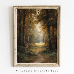 May include: A framed wall art print featuring an oil painting of a forest path winding through tall trees with autumn foliage in shades of brown, gold, and green. The scene depicts a soft, hazy light filtering through the dense canopy of trees.