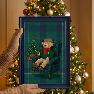 May include: A framed print featuring a teddy bear in a green sweater and red scarf, seated in a plaid armchair. The bear is holding a smoking pipe next to a small Christmas tree. The frame is dark blue, and the background is a decorated Christmas tree.