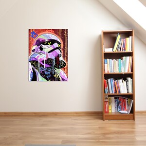 May include: A colorful pop art print of a Stormtrooper helmet. The artwork features vibrant hues of purple, green, and yellow, with graffiti-style text. The background is a mix of red and orange tones. The text on the print reads "Fight for your dreams."