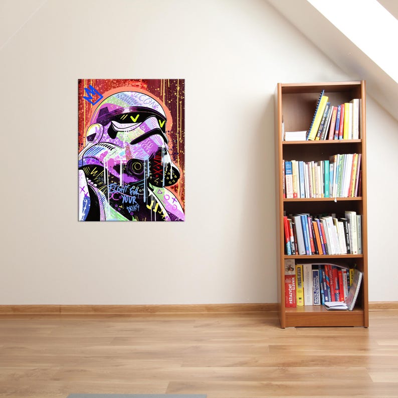 May include: A colorful pop art print of a Stormtrooper helmet. The artwork features vibrant hues of purple, green, and yellow, with graffiti-style text. The background is a mix of red and orange tones. The text on the print reads "Fight for your dreams."
