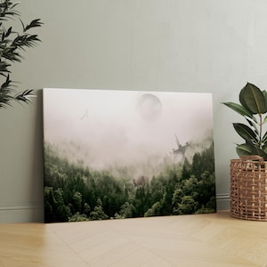 May include: A rectangular canvas wall art print featuring a dense, dark green coniferous forest shrouded in thick, pale gray fog. A large, faint circular moon hangs in the sky above, with a small flying creature and a tall, thin structure visible.