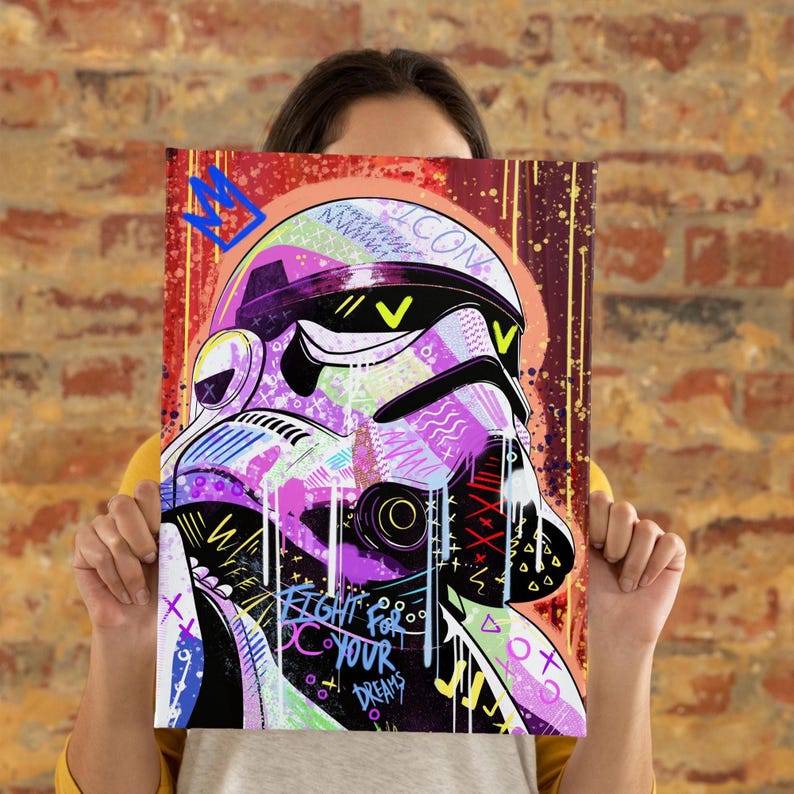 May include: A colorful pop art print featuring a Stormtrooper helmet with vibrant purple, green, and yellow accents. The artwork includes the text "FIGHT FOR YOUR DREAMS" and a crown graphic, set against a red and brown background.