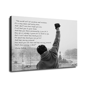 May include: Black and white canvas print featuring a silhouette of a person with their fist raised in the air. The print includes a quote from Rocky Balboa about overcoming challenges and the harsh realities of life.