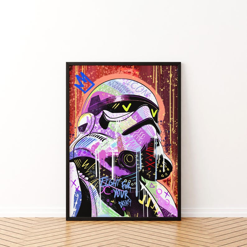 May include: A framed art print featuring a stylized Stormtrooper helmet with graffiti-style artwork. The helmet is rendered in vibrant colors including purple, green, and yellow, with the words "FIGHT FOR YOUR DREAMS".