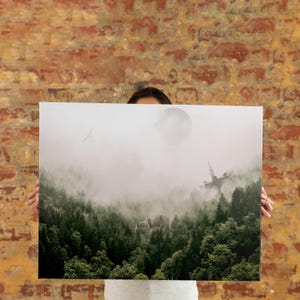 May include: A rectangular canvas print featuring a dense, dark green coniferous forest shrouded in thick, low-hanging fog. A large, pale moon hangs in the sky, while a tall, metallic, antenna-like structure rises above the treetops.