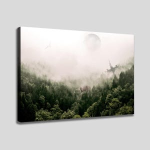 May include: A rectangular canvas print featuring a dense, dark green coniferous forest shrouded in thick white fog. A large, circular moon hangs in the pale sky above, while a mechanical walker and a distant spacecraft are visible in the mist.