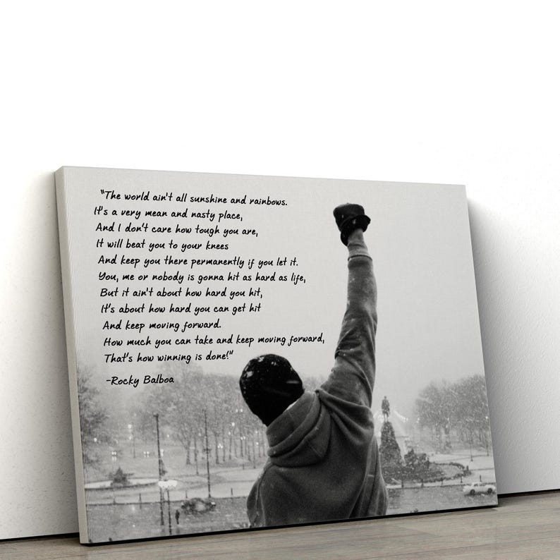 May include: Black and white canvas print featuring a silhouette of a person with a raised fist, with a quote from Rocky Balboa. The quote is about perseverance and overcoming challenges. The background shows a snowy outdoor scene.