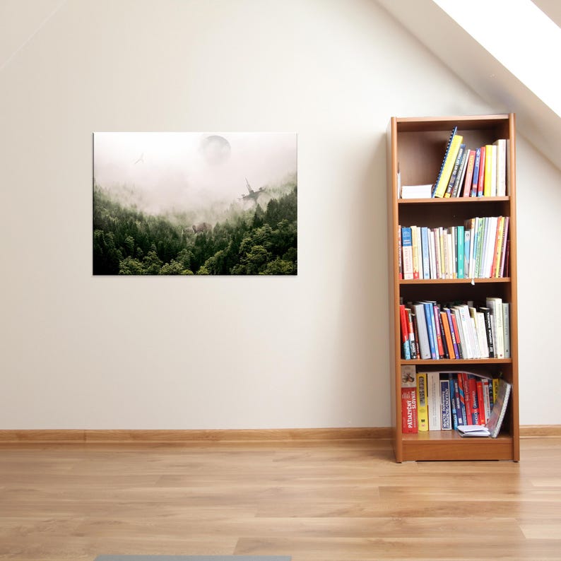 May include: A rectangular wall art print depicting a dense, misty forest with a faint moon and a distant, sharp-edged structure visible through the fog. Beside the print stands a tall, wooden bookshelf filled with various books on four shelves.