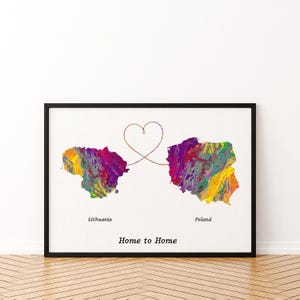 May include: A framed print featuring colorful abstract maps of Lithuania and Poland connected by a heart-shaped line. The words "Lithuania", "Poland", and "Home to Home" are printed below the maps. The artwork is set against a white background.