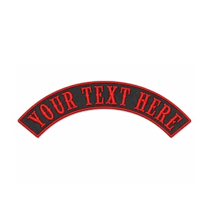 May include: Black, arched patch with red embroidered text that reads "YOUR TEXT HERE". The patch has a red border and is designed to be sewn onto clothing or accessories. The text is in a bold, stylized font.