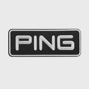 May include: A rectangular embroidered patch featuring a black background with a white border and the word PING stitched in large, bold, white capital letters. The design has a textured, fabric-like appearance with visible thread stitching throughout.