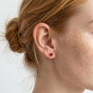 May include: A set of three ceramic mugs with a speckled, matte finish. The mugs are in shades of cream, light gray, and dark gray. Each mug has a simple, modern design and a rounded handle.